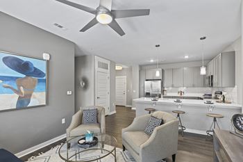 An open living room and kitchen with a ceiling fan